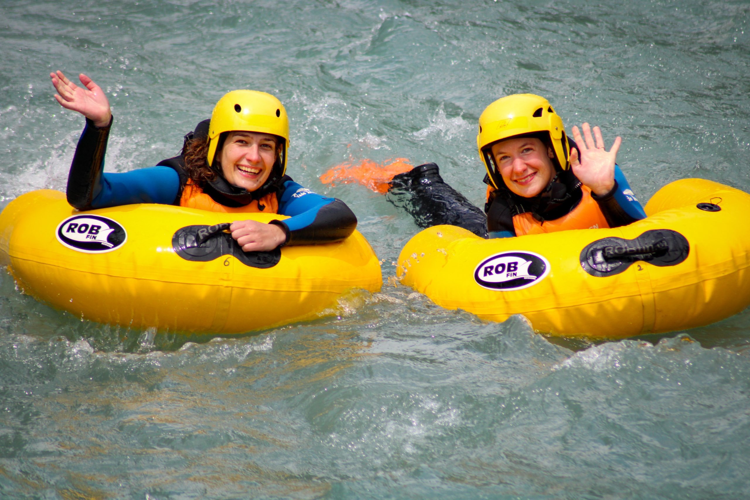 The girls on the river in hydrospeed, smiling.